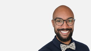 A profile photo of Christopher Washington with glasses and dark shirt and bow tie
