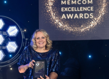 Rebecca Nicholls holding her winning trophy for the Memcom Excellence Awards